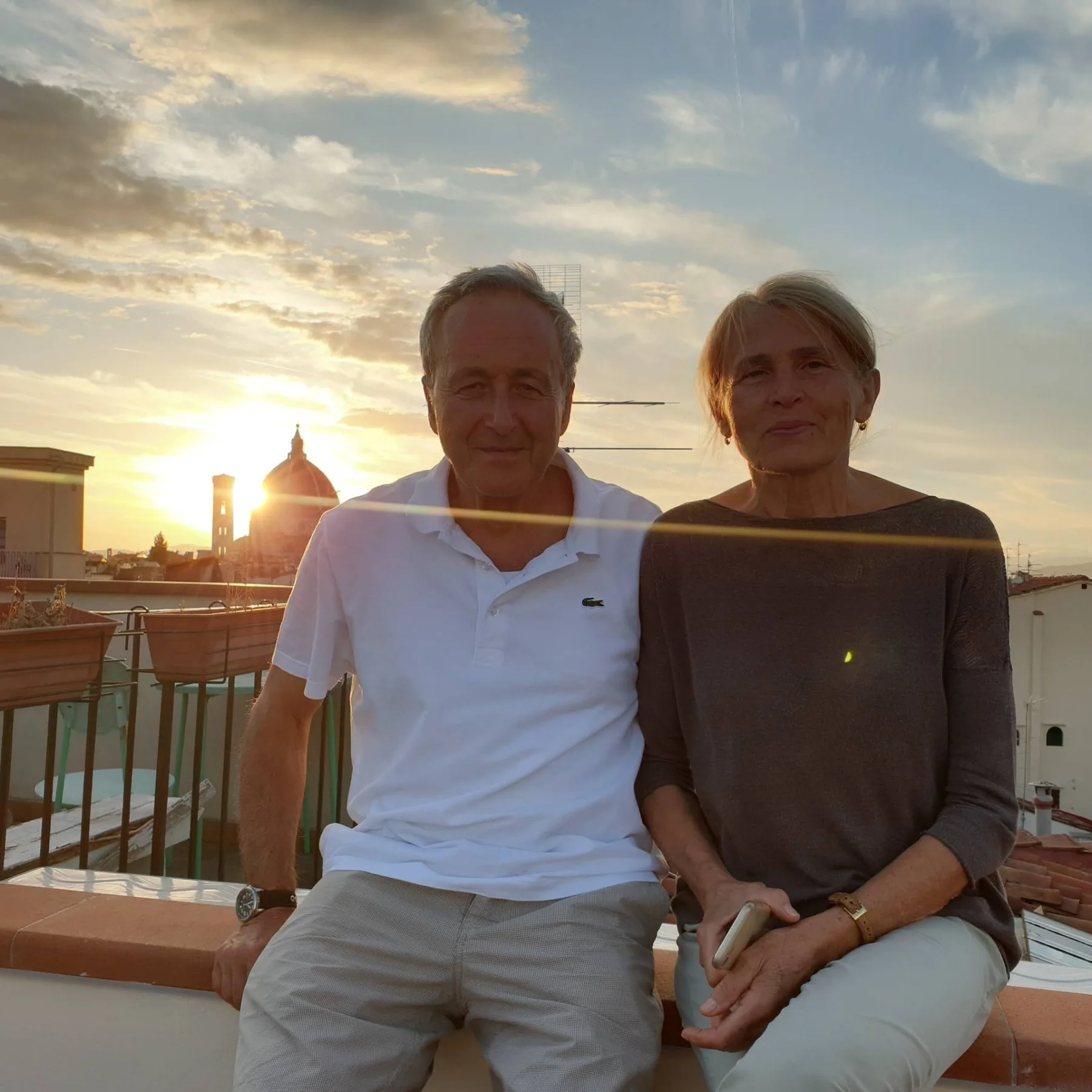 An older couple sitting together at sunset