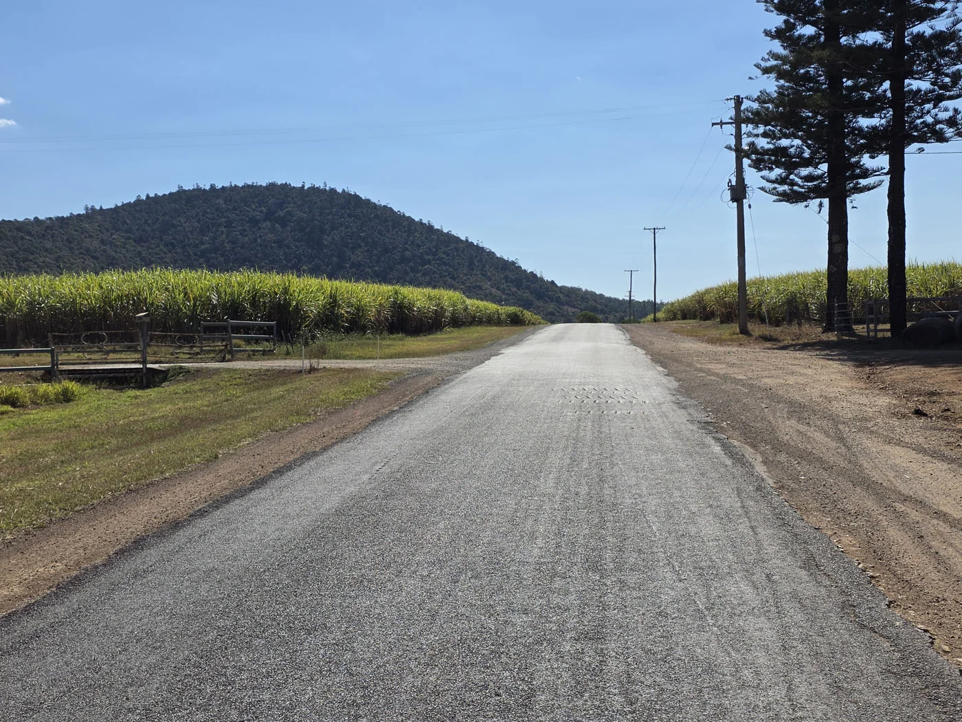 Quiet country road into Bauple with fields and hills in the distance