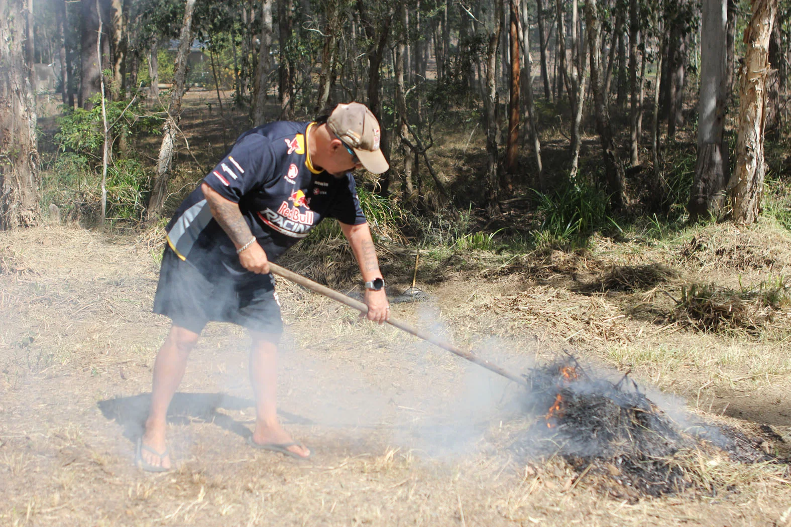A Glenwood resident clearing vegetation beside a smoking drain area
