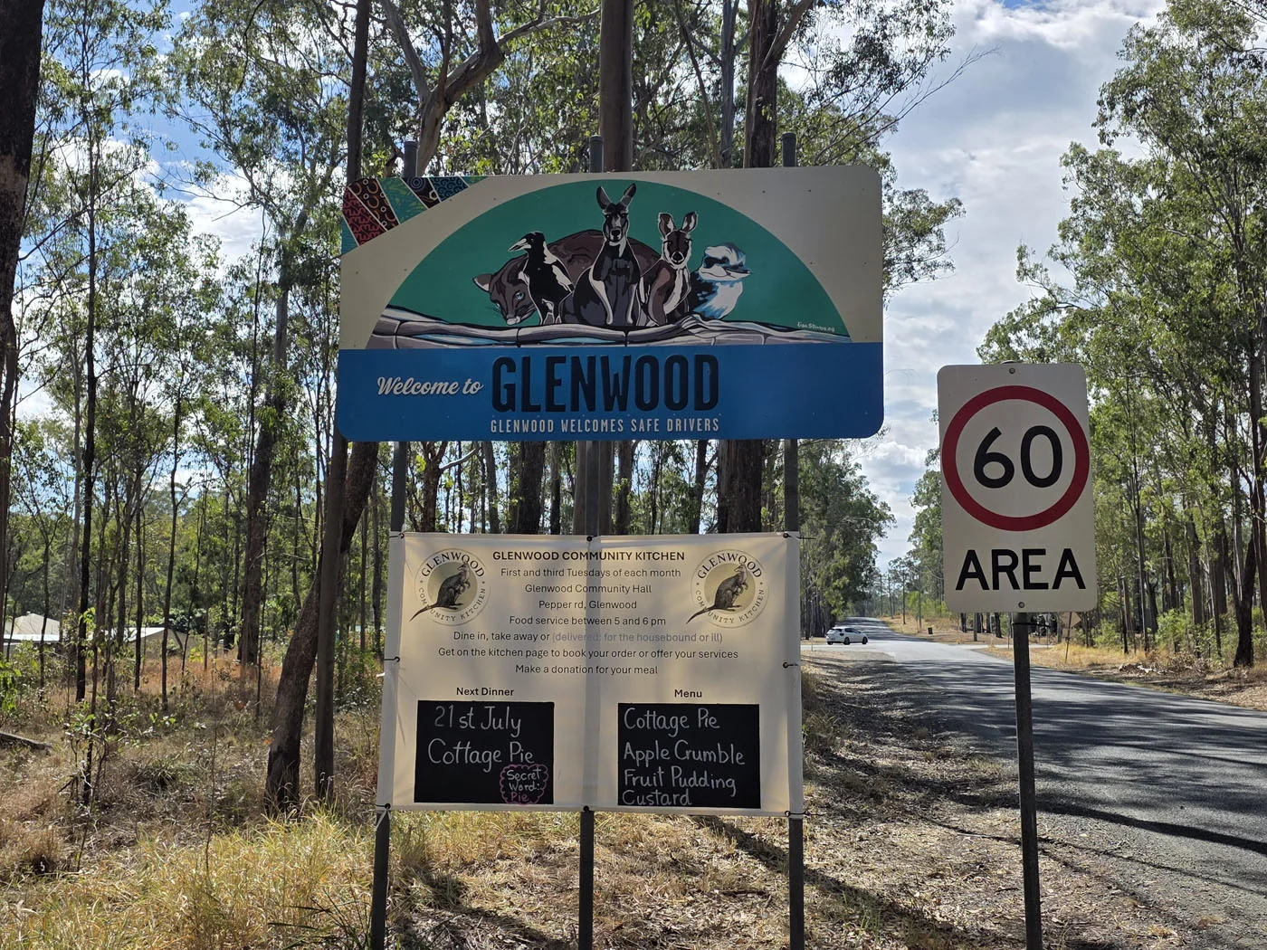 Welcome to Glenwood sign beside a tree-lined local road
